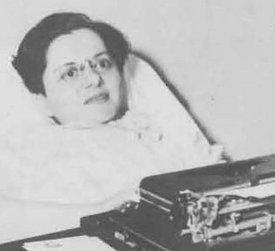 Jane Merchant holding one of her books and at her typewriter